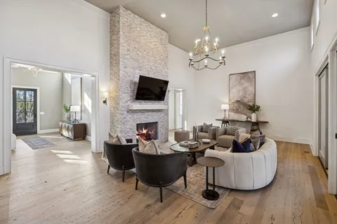 a kitchen with stainless steel appliances granite countertop a table chairs stove and cabinets
