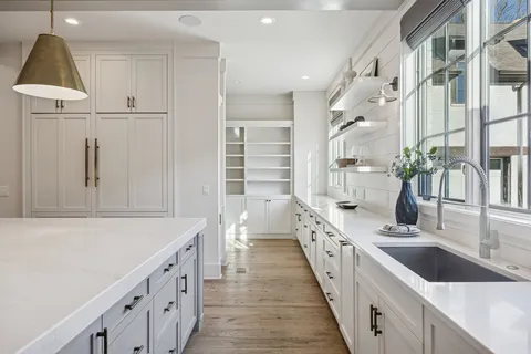 a bathroom with a granite countertop sink a mirror and a shower