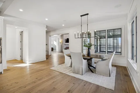 a view of a hallway with wooden floor and closet area