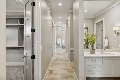 an empty room with wooden floor closet and windows