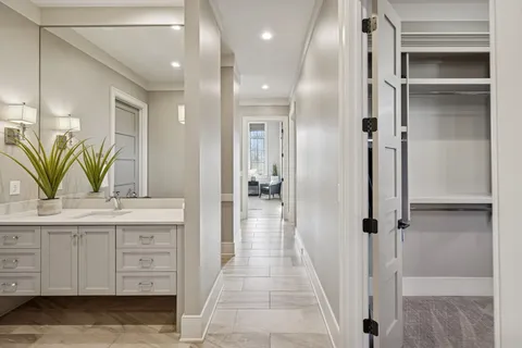 a view of a hallway with wooden floor and closet area