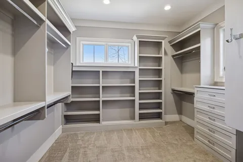 a spacious bathroom with a double vanity sink a mirror and a shower