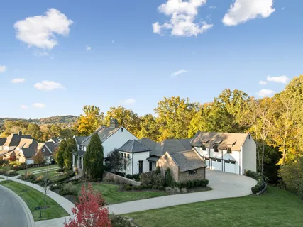 an aerial view of residential houses with outdoor space and swimming pool