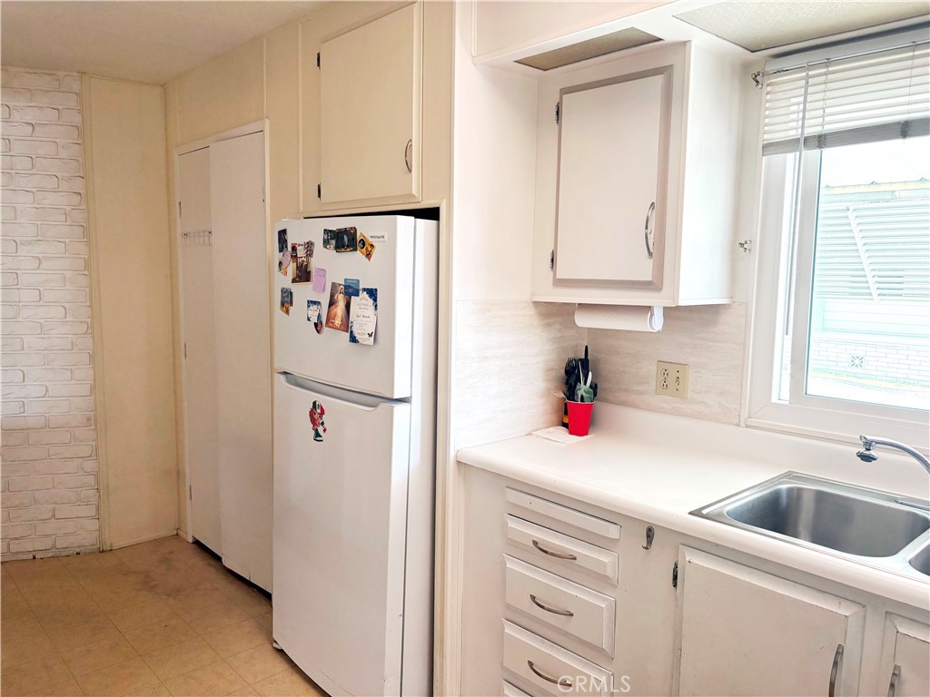 14851 Jeffrey Road, Unit 248 Irvine, CA 92618 - Photo 3 of 6 a kitchen with white cabinets and white appliances