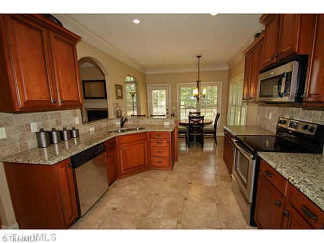 223 Essex Farm Road Advance, NC 27006 - Photo 3 of 16 Kitchen. Beautiful Kitchen with Granite, 16 inch tile flooring, gorgeous back splash and built in desk