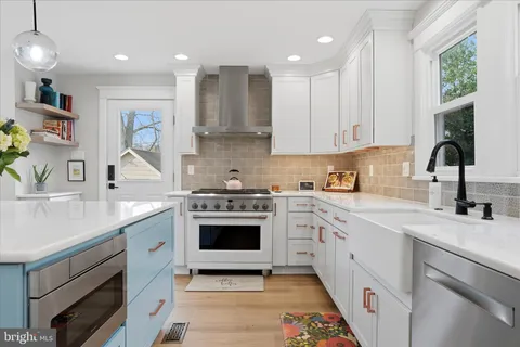 a kitchen with a sink stove and cabinets