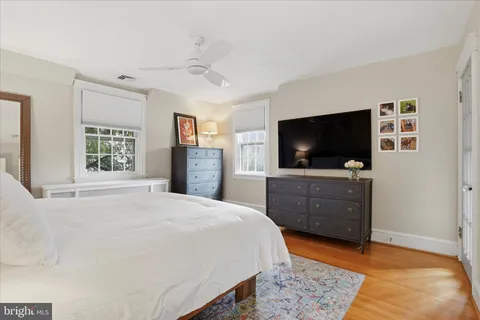 a bedroom with a bed and a flat screen tv in it