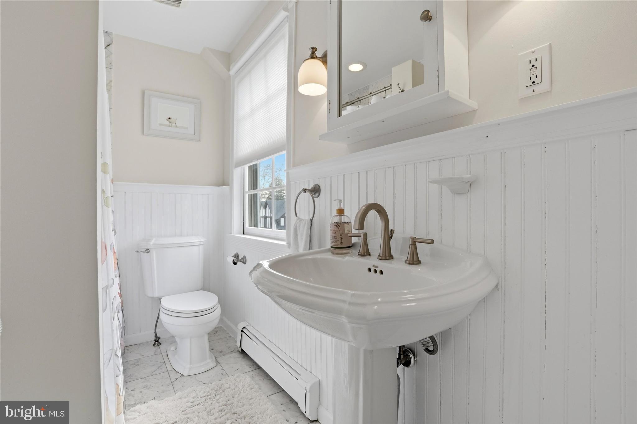 310 Old Forest Road Wynnewood, PA 19096 - Photo 26 of 35 a bathroom with a sink a toilet and a mirror