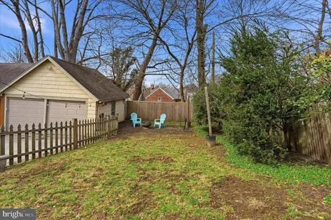 a view of a house with a yard and tree