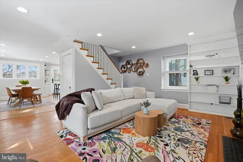 a living room with furniture and wooden floor