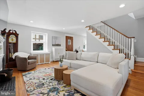 a living room with furniture a rug and a window