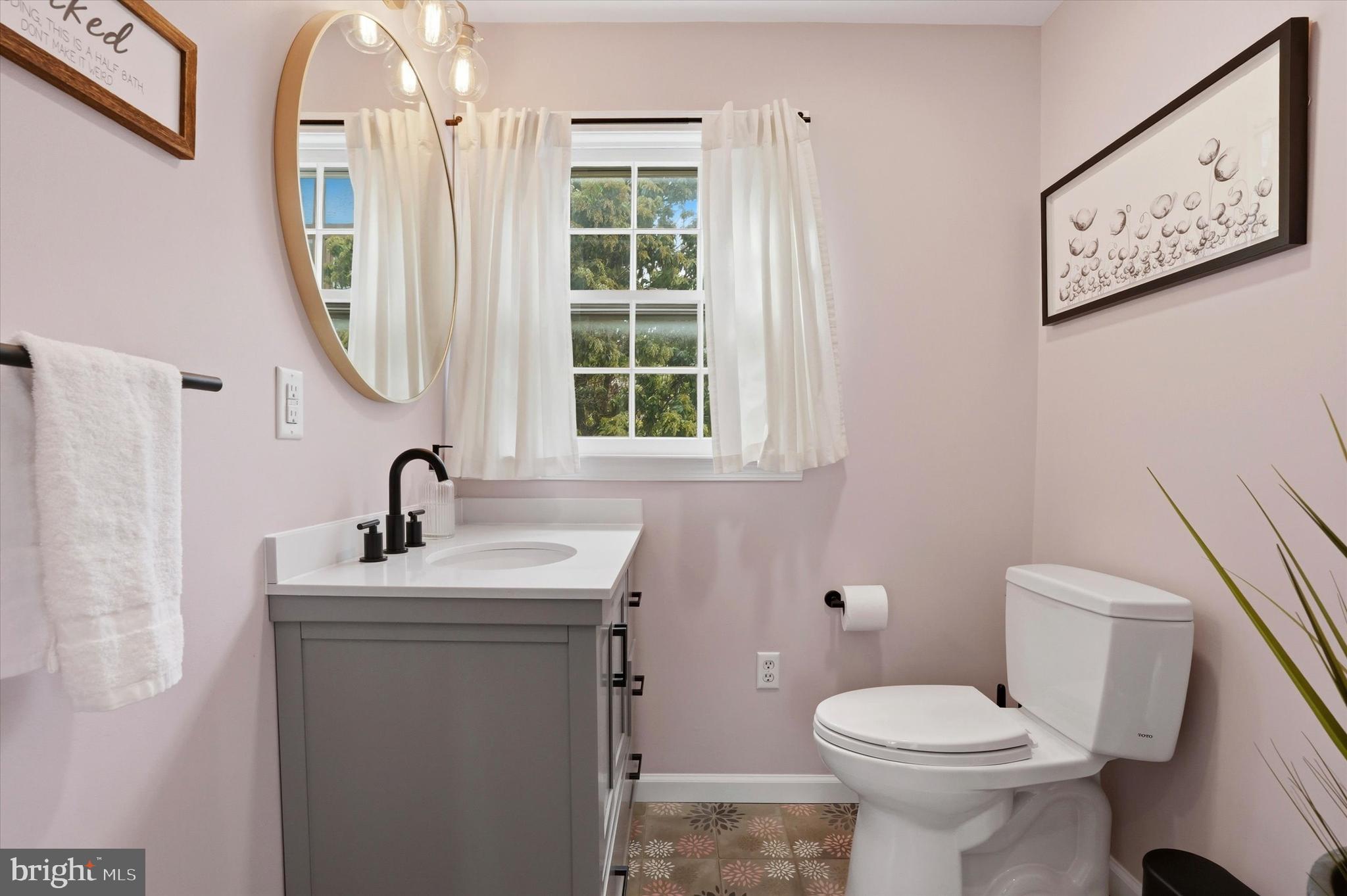 310 Old Forest Road Wynnewood, PA 19096 - Photo 10 of 35 a bathroom with a toilet sink and mirror