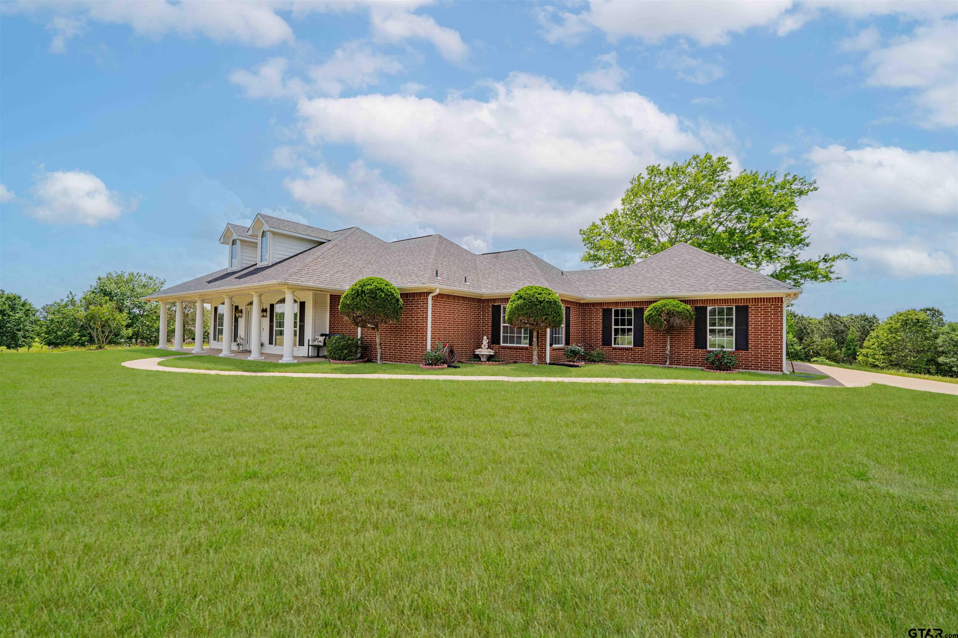 1855 Phillips Springs Road Gladewater, TX 75647 - Photo 24 of 36 a front view of a house with garden