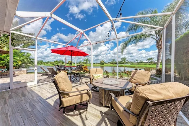 a view of a patio with a dining table and chairs under an umbrella