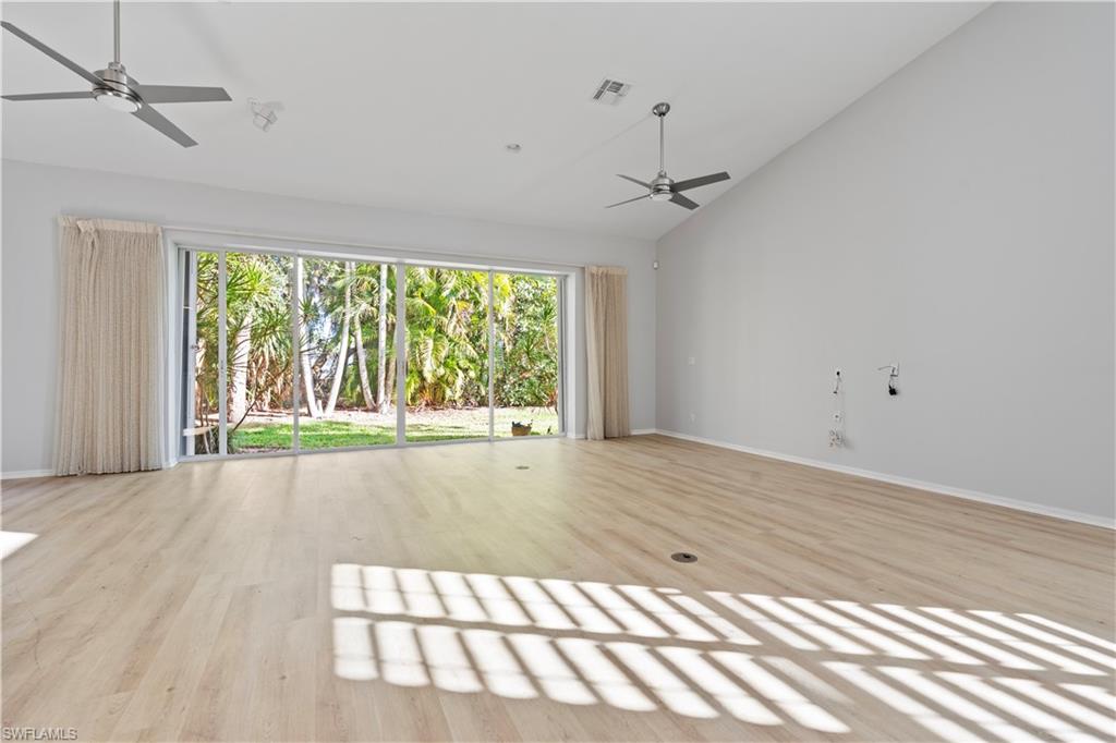 20751 Rivers Ford Estero, FL 33928 - Photo 20 of 36 Unfurnished living room with a ceiling fan, light wood-type flooring, and high vaulted ceiling