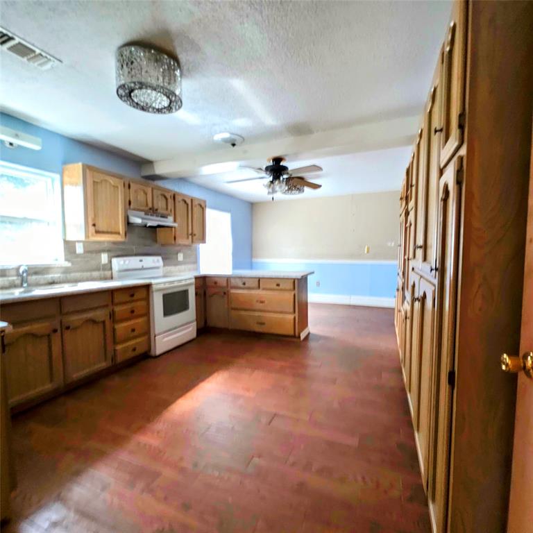 285 Montgomery Road Mineral Wells, TX 76067 - Photo 11 of 26 a kitchen with a stove a sink and a refrigerator
