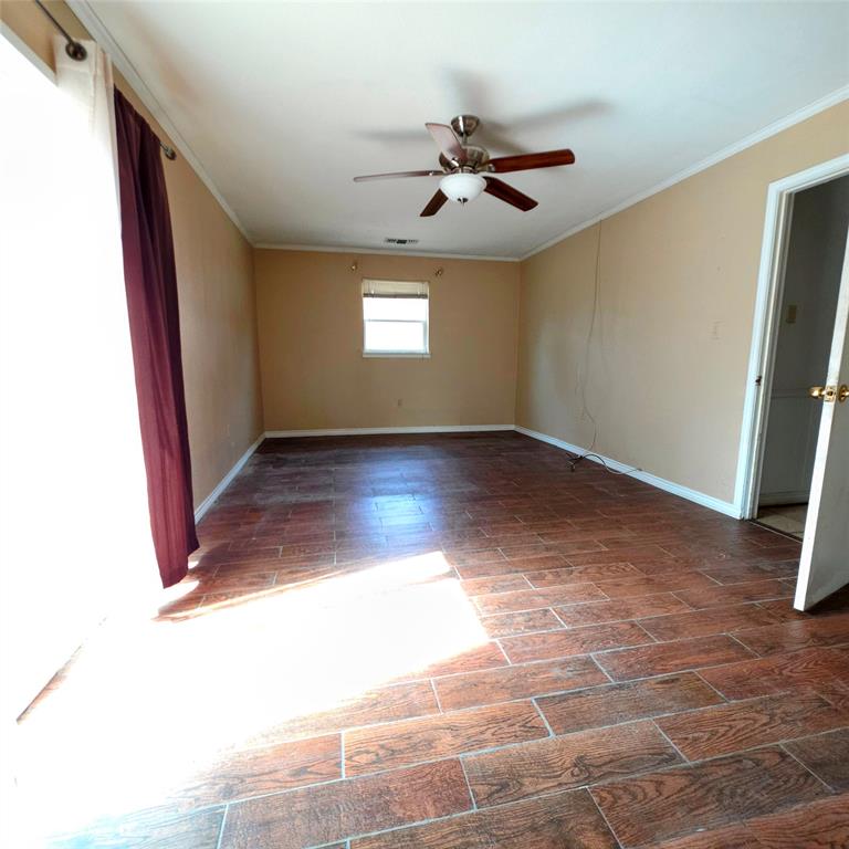 285 Montgomery Road Mineral Wells, TX 76067 - Photo 16 of 26 a view of an empty room with wooden floor and a window