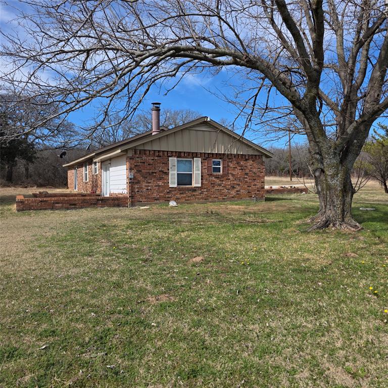 285 Montgomery Road Mineral Wells, TX 76067 - Photo 22 of 26 a yellow house in middle of the forest
