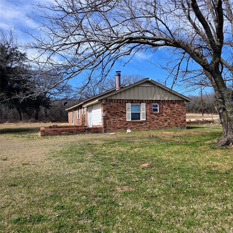285 Montgomery Road Mineral Wells, TX 76067 - Photo 23 of 26 a front view of a house with garden