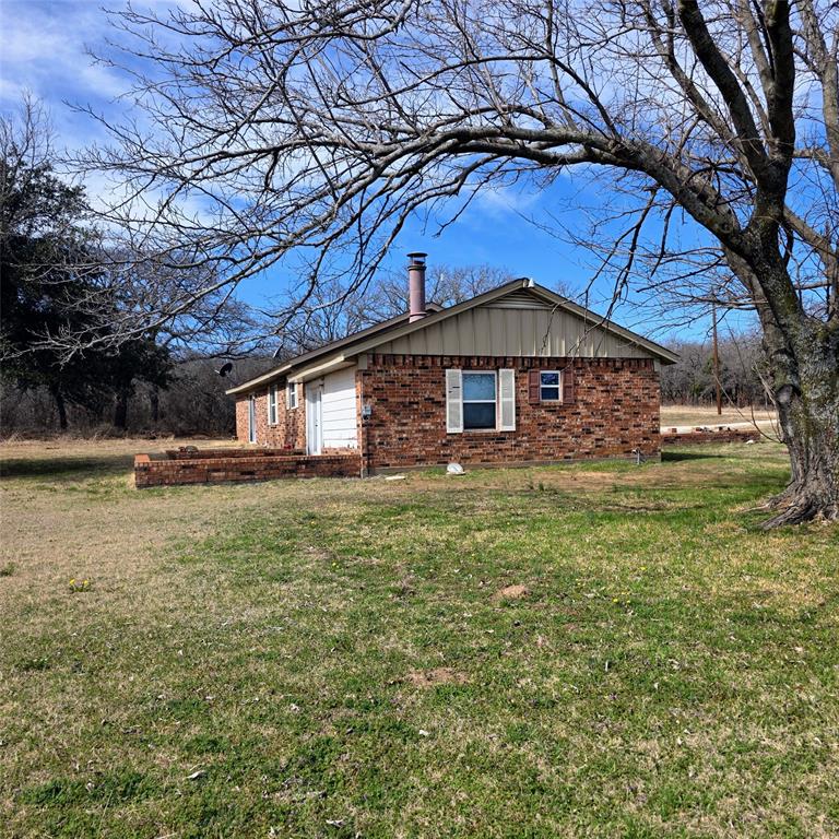 285 Montgomery Road Mineral Wells, TX 76067 - Photo 24 of 26 a front view of a house with garden