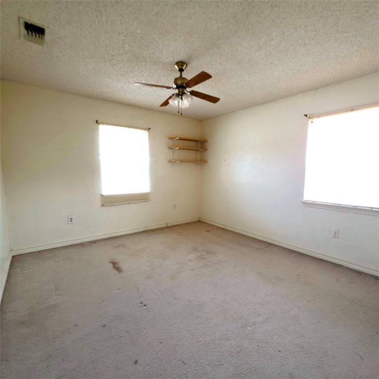 285 Montgomery Road Mineral Wells, TX 76067 - Photo 7 of 26 an empty room with windows and fan
