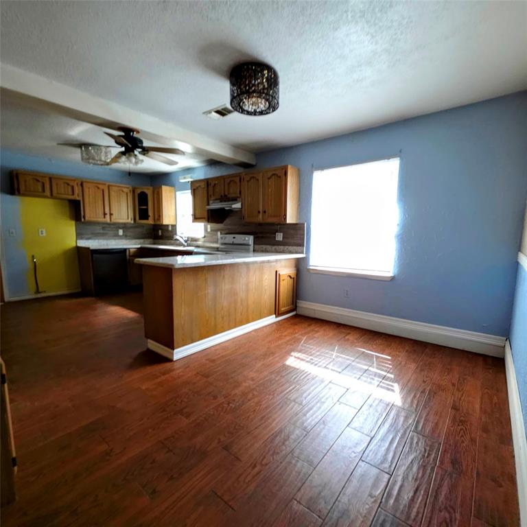 285 Montgomery Road Mineral Wells, TX 76067 - Photo 10 of 26 a kitchen with stainless steel appliances granite countertop a stove and a wooden floors