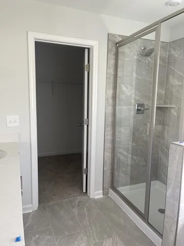 a bathroom with a shower and a sink