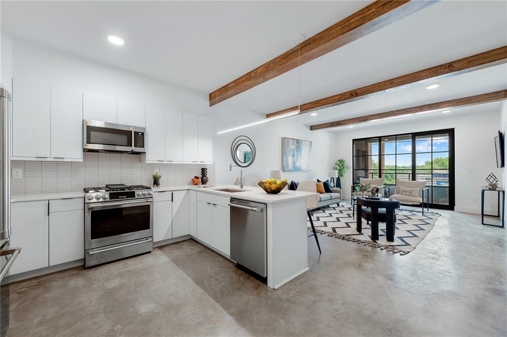 346 Peters Street Southwest, Unit 303 Atlanta, GA 30313 - Photo 1 of 1 a kitchen with a sink and a stove top oven
