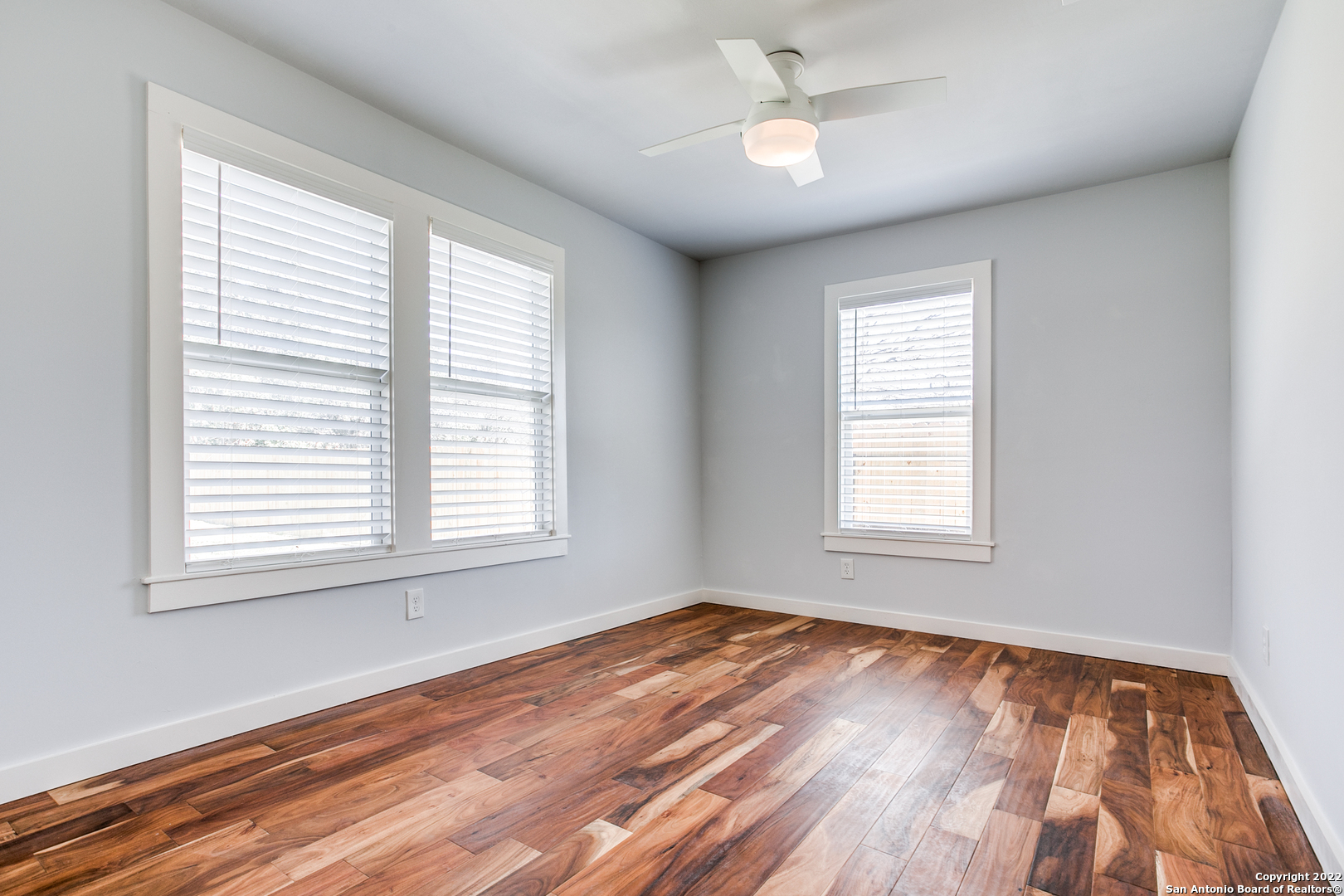 311 Clarence Street San Antonio, TX 78212 - Photo 11 of 23 a view of an empty room with wooden floor and a window