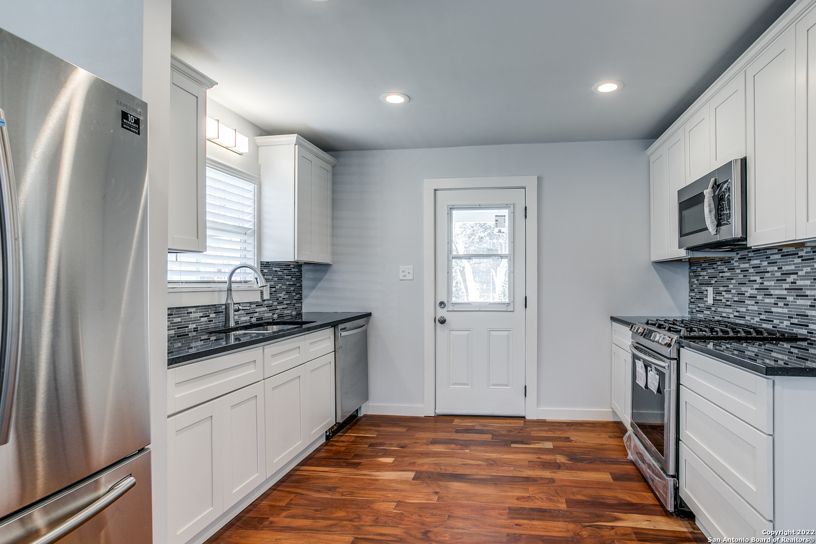 311 Clarence Street San Antonio, TX 78212 - Photo 12 of 23 a kitchen with stainless steel appliances granite countertop a stove a sink and a refrigerator