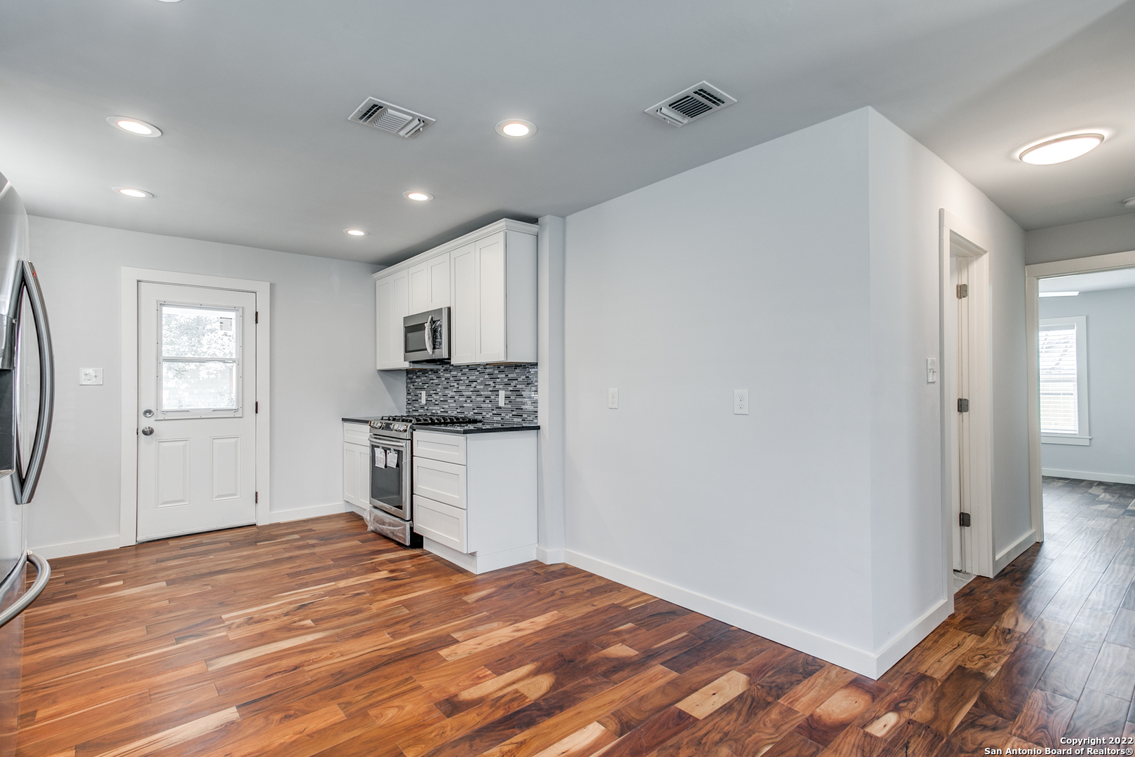 311 Clarence Street San Antonio, TX 78212 - Photo 13 of 23 a kitchen with a refrigerator and window
