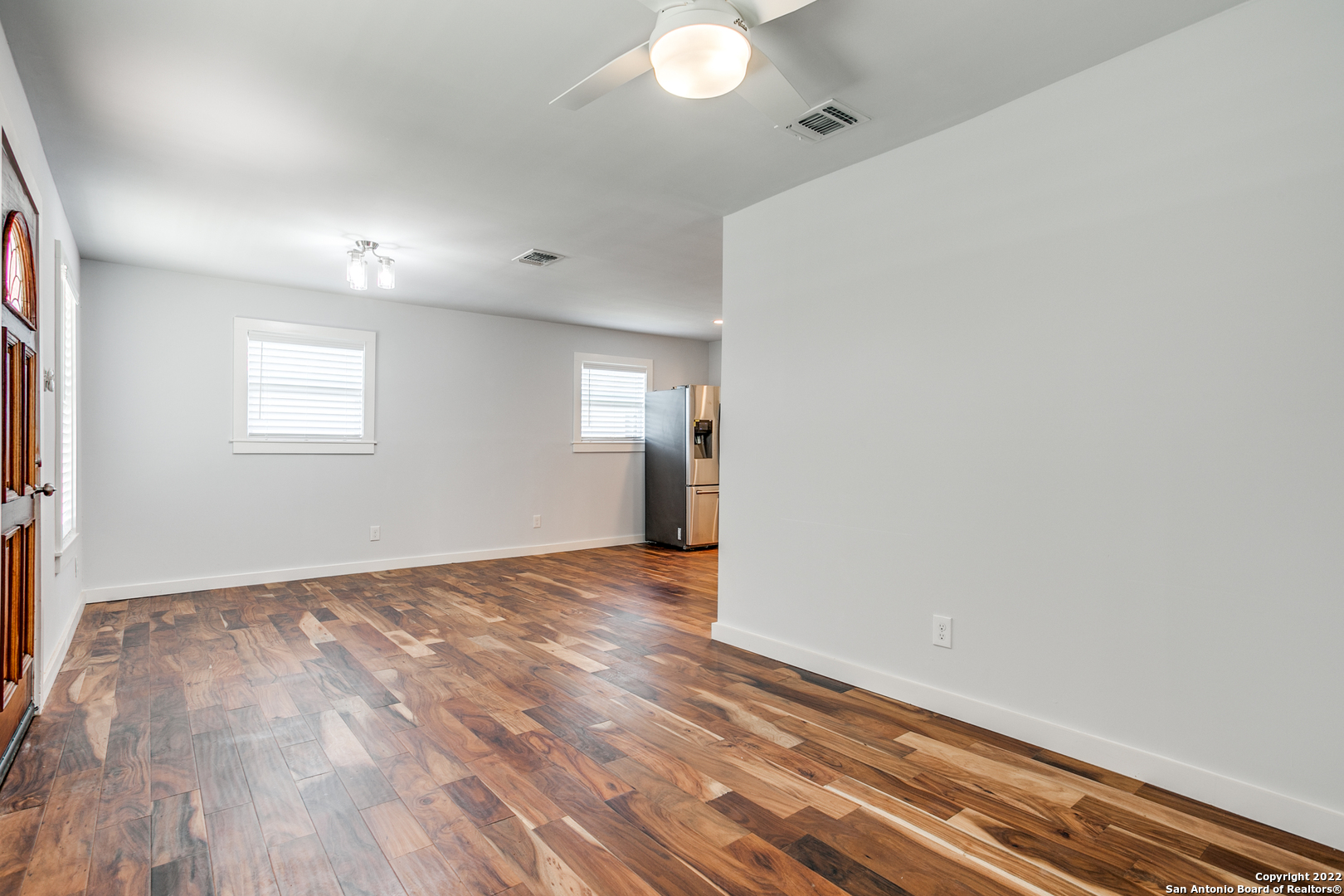 311 Clarence Street San Antonio, TX 78212 - Photo 16 of 23 a view of an empty room with wooden floor and a window
