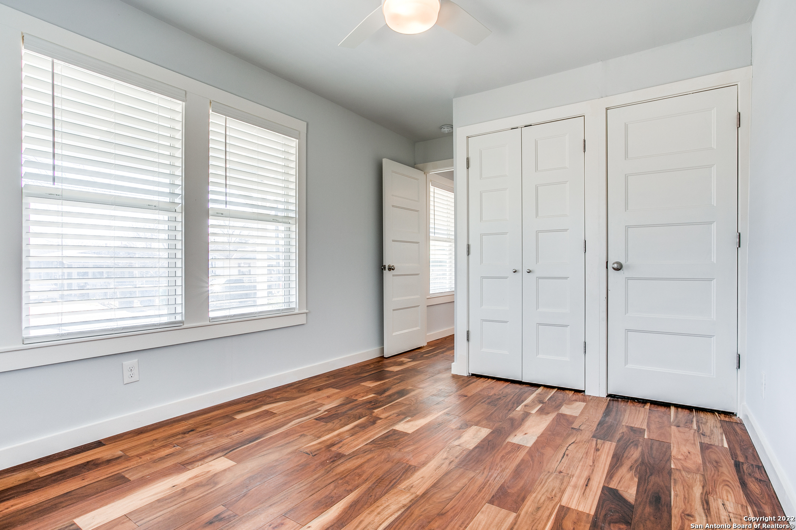 311 Clarence Street San Antonio, TX 78212 - Photo 19 of 23 an empty room with wooden floor closet and windows