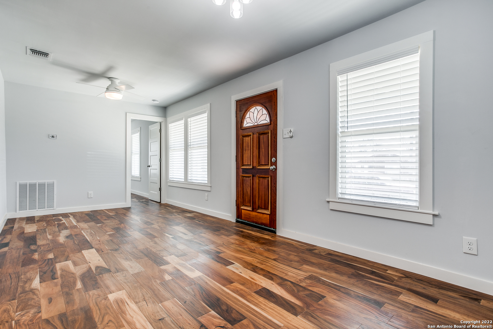 311 Clarence Street San Antonio, TX 78212 - Photo 5 of 23 a view of an empty room with wooden floor and a window