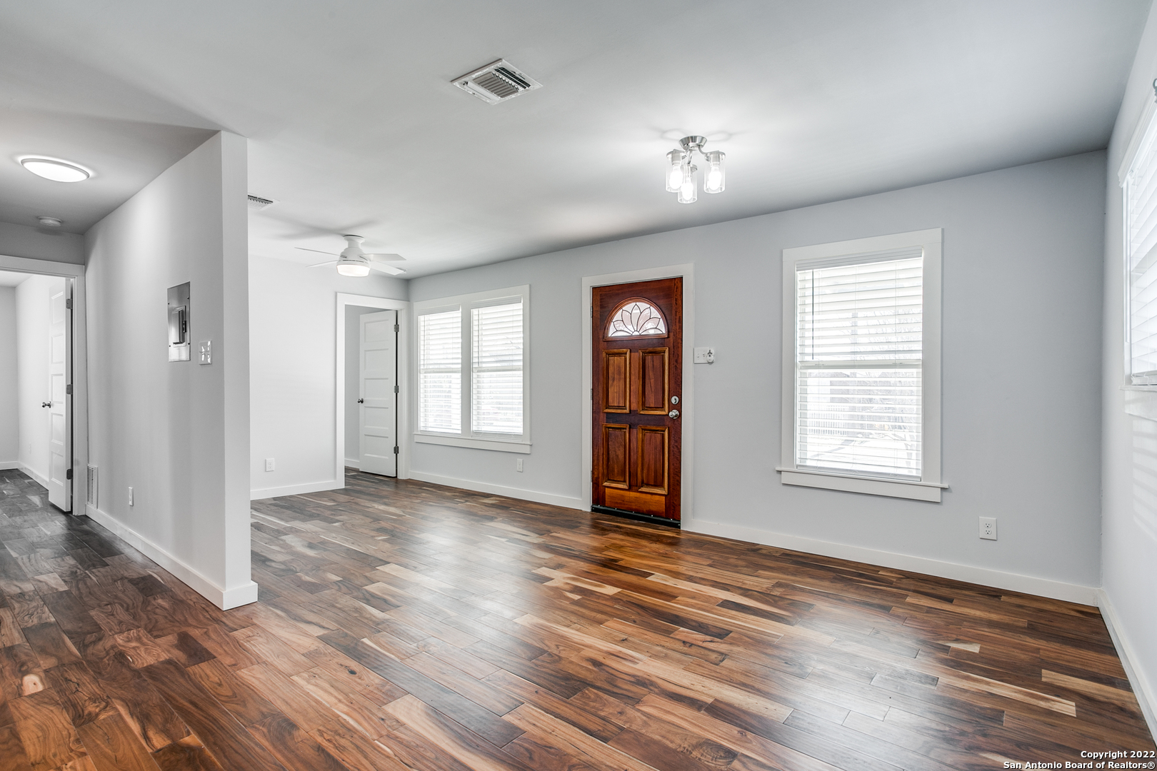 311 Clarence Street San Antonio, TX 78212 - Photo 7 of 23 an empty room with wooden floor and windows