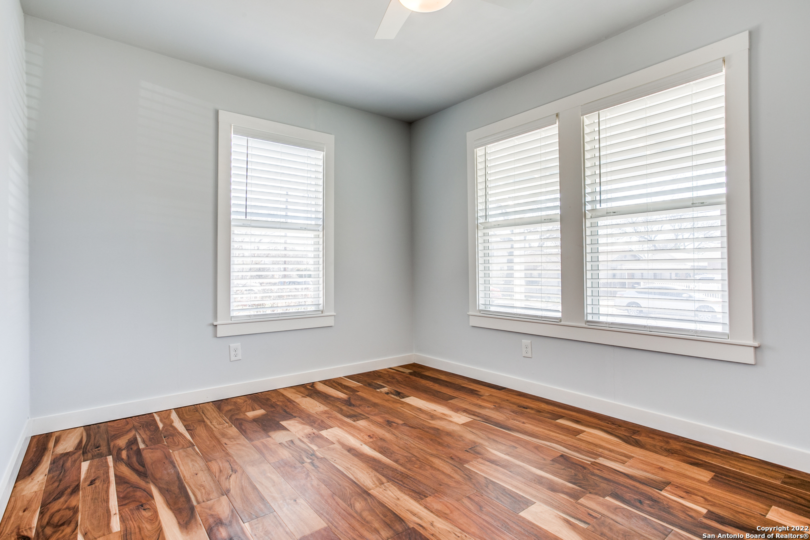 311 Clarence Street San Antonio, TX 78212 - Photo 8 of 23 a view of an empty room with wooden floor and a window
