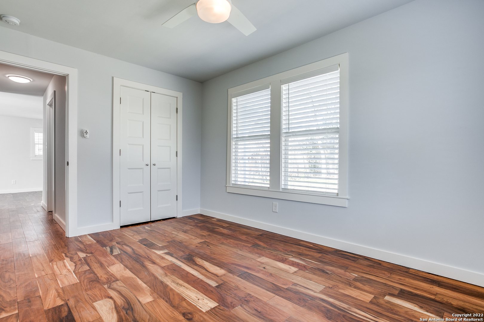 311 Clarence Street San Antonio, TX 78212 - Photo 10 of 23 a view of empty room with wooden floor and fan