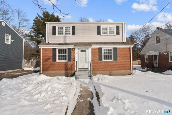 a view of a house with a snow in the background