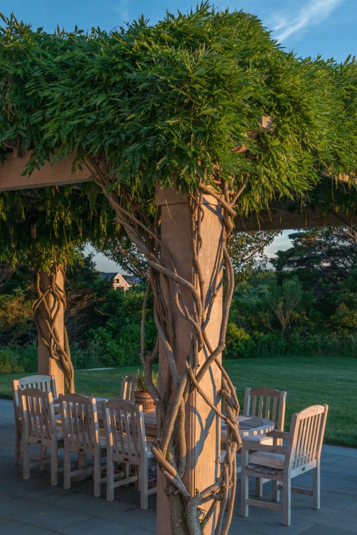 20 Berkeley Avenue Nantucket, MA 02554 - Photo 24 of 30 a backyard of a house with table and chairs