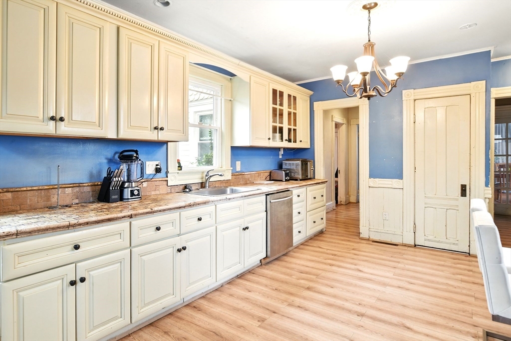 346 Maple Street Springfield, MA 01105 - Photo 15 of 36 a kitchen with granite countertop white cabinets and window