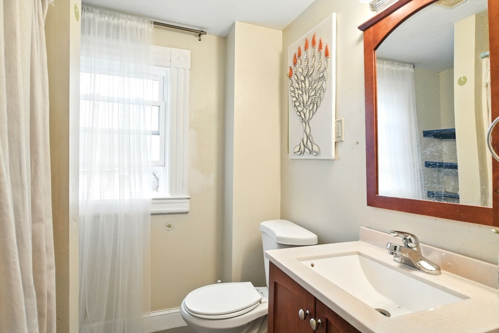 346 Maple Street Springfield, MA 01105 - Photo 17 of 36 a bathroom with a sink a toilet and shower curtain