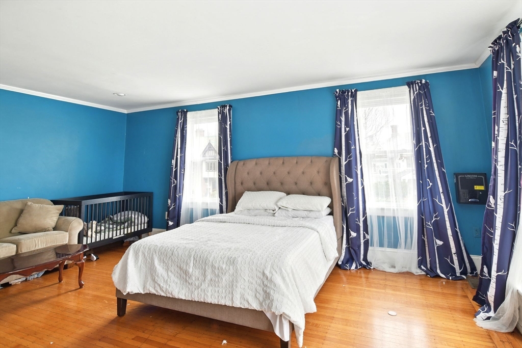 346 Maple Street Springfield, MA 01105 - Photo 21 of 36 a bedroom with a bed a couch and a window