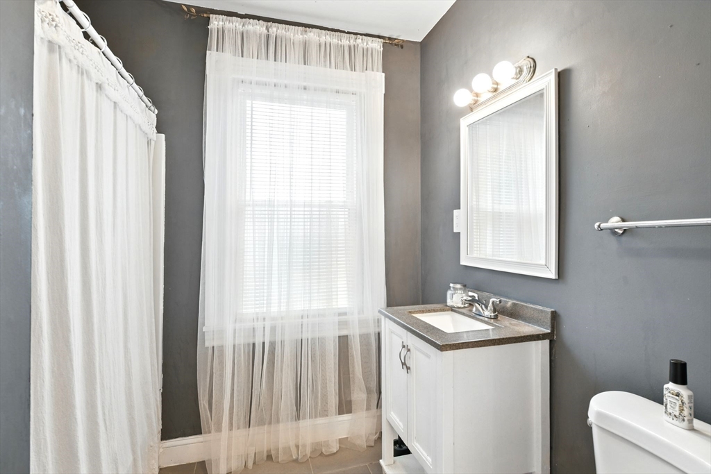 346 Maple Street Springfield, MA 01105 - Photo 24 of 36 a bathroom with a sink vanity and a mirror