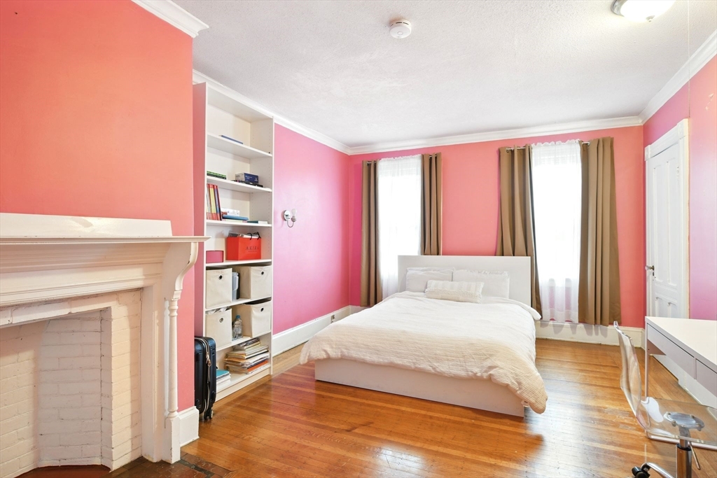 346 Maple Street Springfield, MA 01105 - Photo 25 of 36 a bedroom with a bed and a book shelf