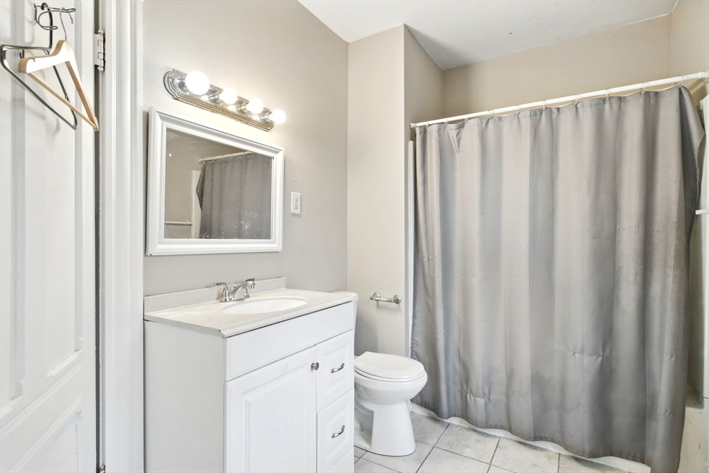 346 Maple Street Springfield, MA 01105 - Photo 27 of 36 a bathroom with a sink a toilet and shower curtain