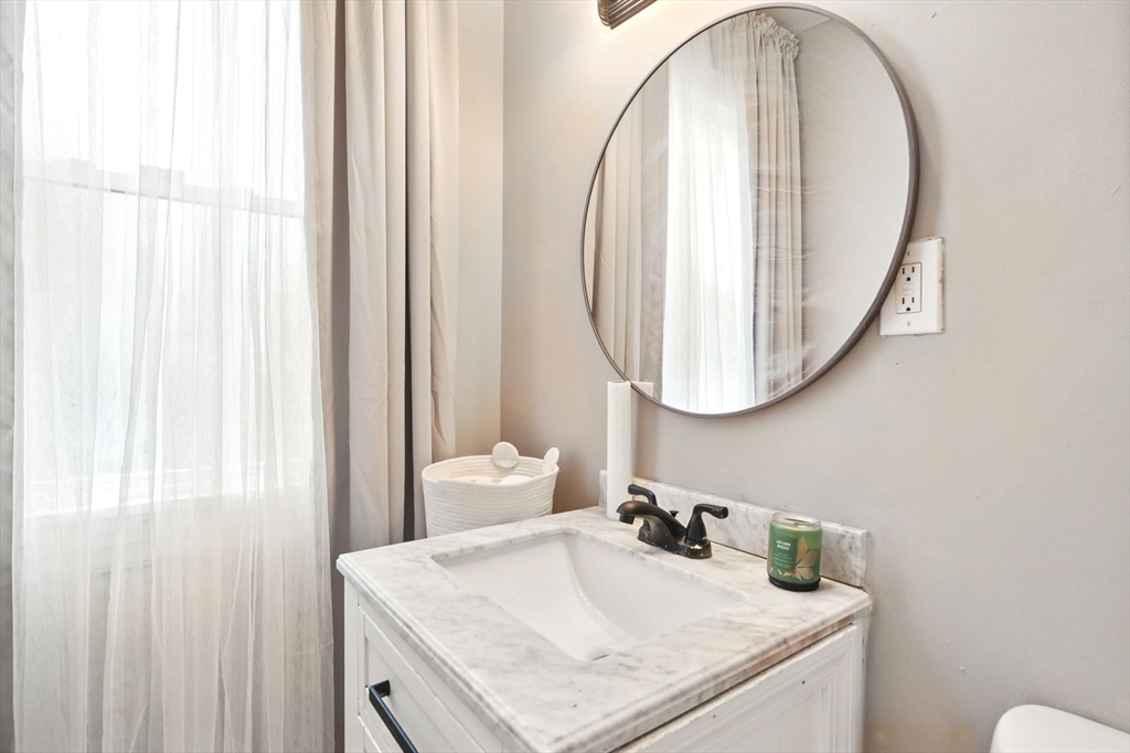 346 Maple Street Springfield, MA 01105 - Photo 31 of 36 a bathroom with a sink and a mirror