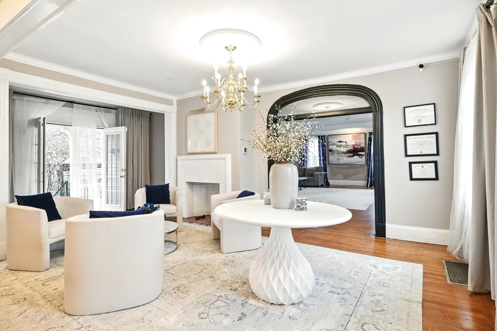 346 Maple Street Springfield, MA 01105 - Photo 7 of 36 a dining room with wooden floor a chandelier a wooden table and chairs