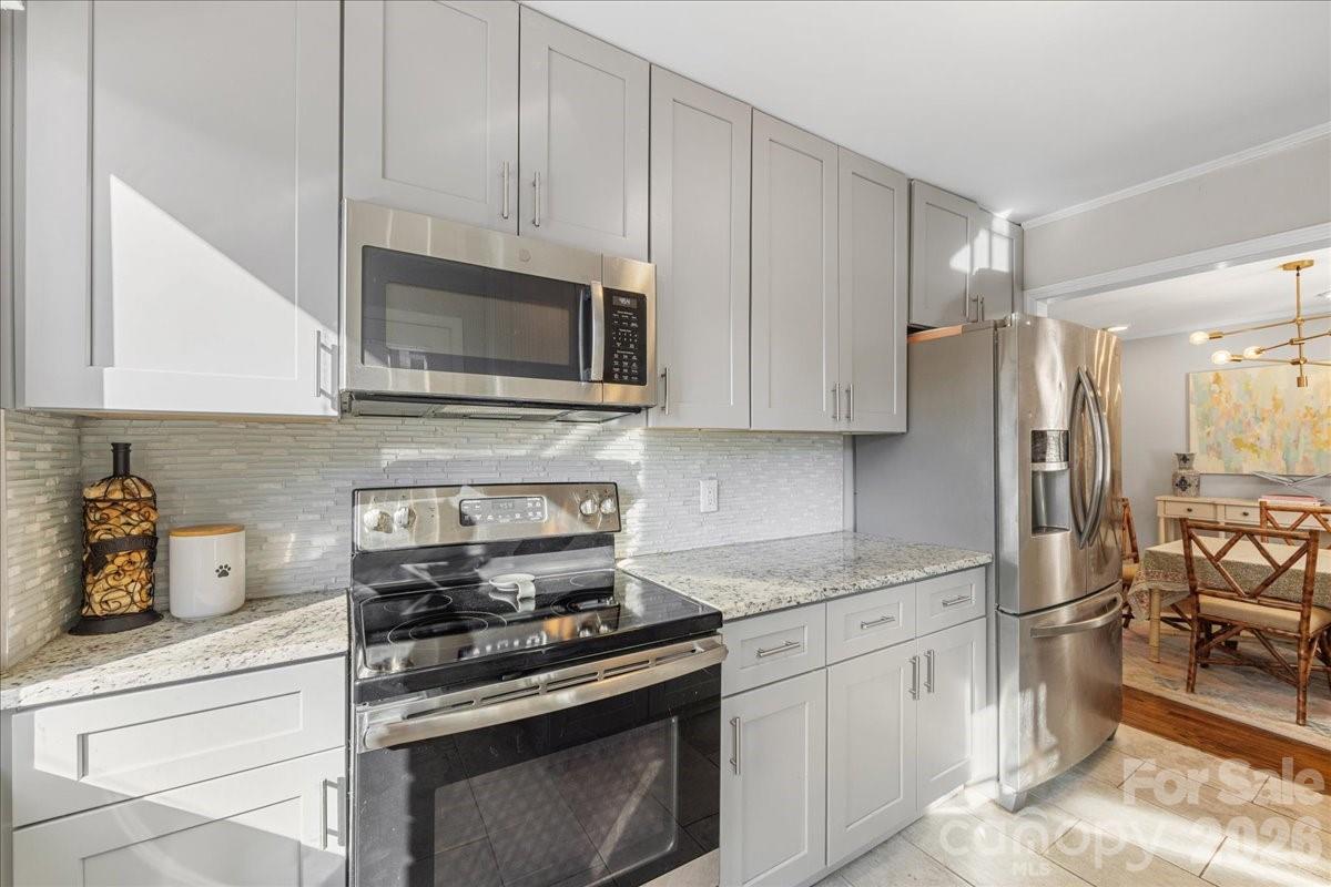 4922 Valley Stream Road Charlotte, NC 28209 - Photo 15 of 33 a kitchen with cabinets stainless steel appliances and a counter top space