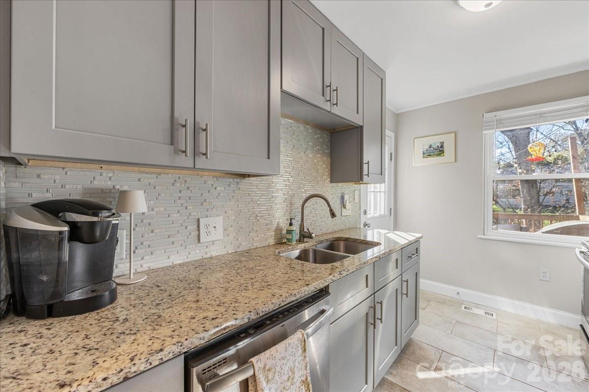 4922 Valley Stream Road Charlotte, NC 28209 - Photo 16 of 33 a kitchen with stainless steel appliances granite countertop a sink stove and cabinets
