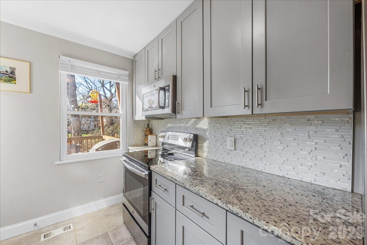 4922 Valley Stream Road Charlotte, NC 28209 - Photo 17 of 33 a kitchen with stainless steel appliances granite countertop a sink a stove and cabinets